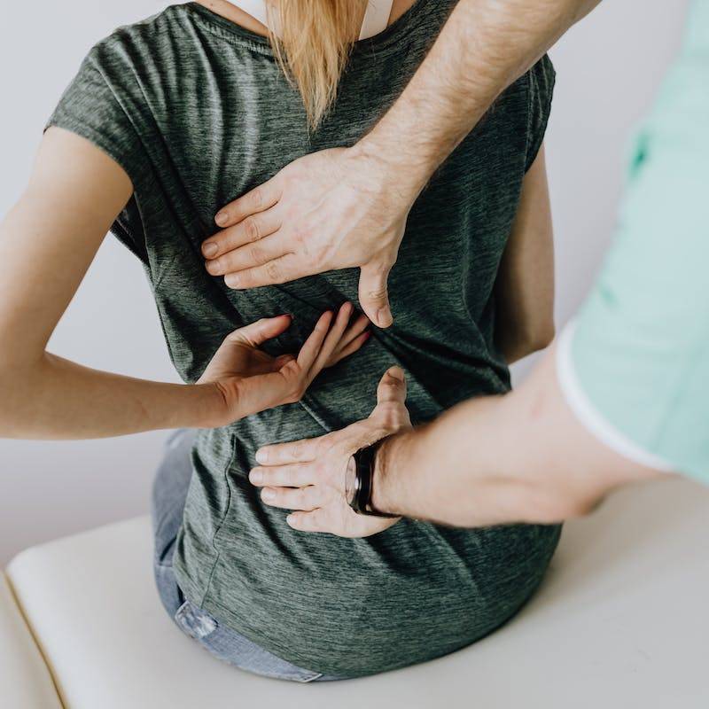 Doctor Examines Woman's back