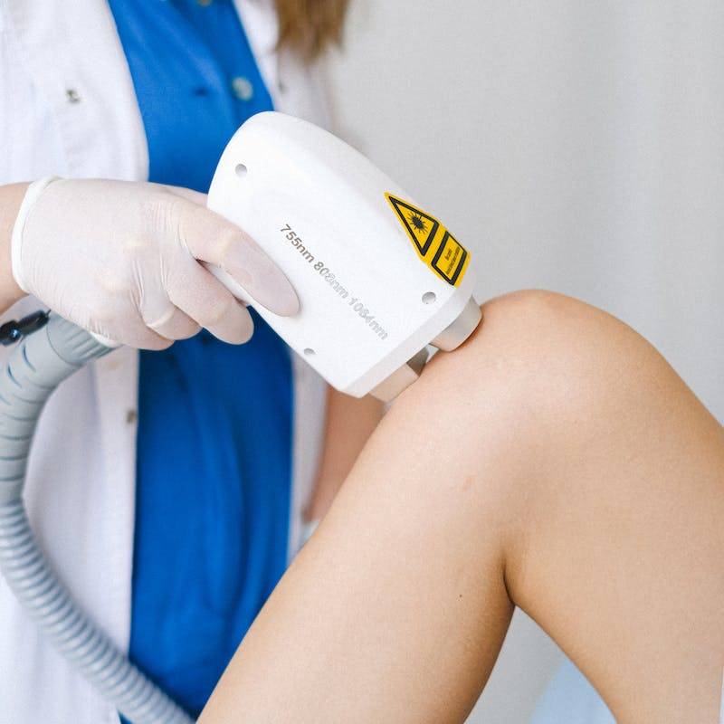 Doctor in formal clothes doing low level laser therapy