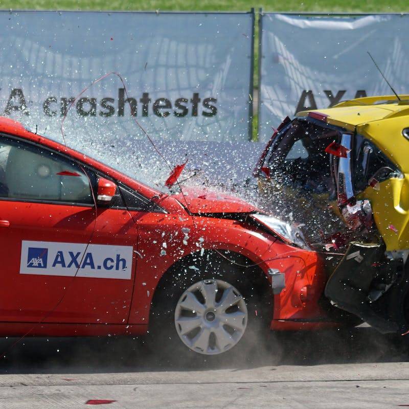 Red and Yellow Hatchback Axa Crash Tests