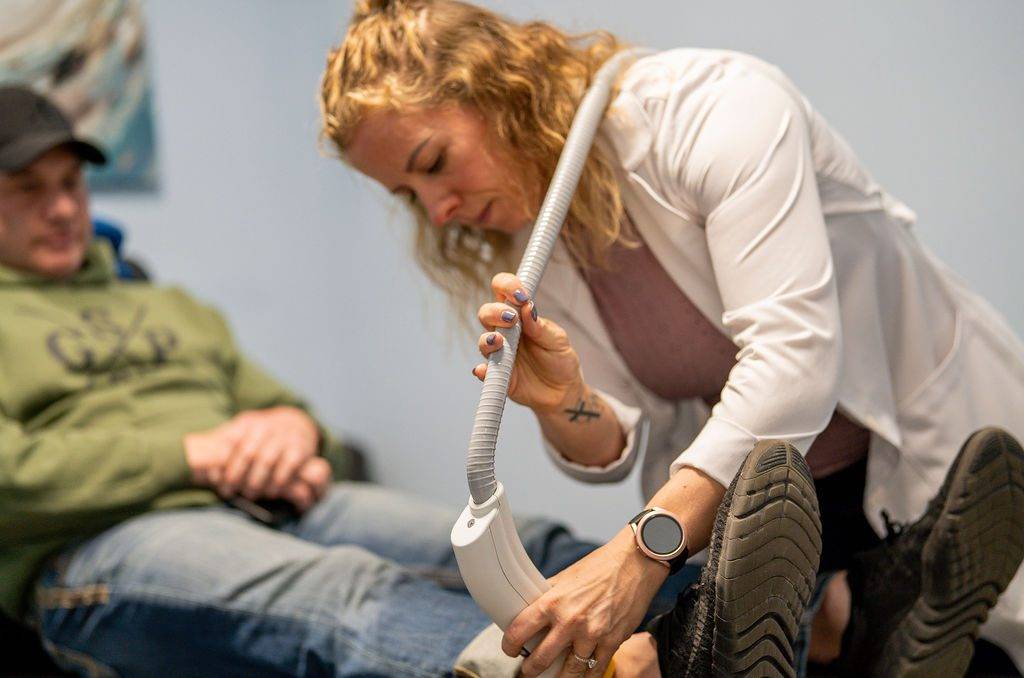 a woman is being examined by a stemwave therapy
